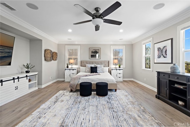 bedroom with crown molding, light hardwood / wood-style floors, and ceiling fan