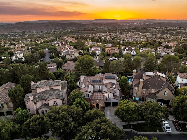 aerial view at dusk featuring a mountain view