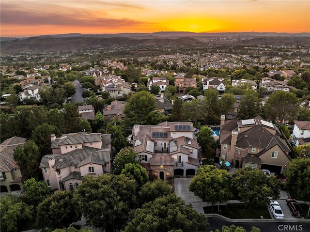 aerial view at dusk featuring a mountain view