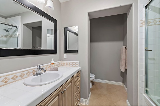 full bathroom featuring vanity, bath / shower combo with glass door, and toilet