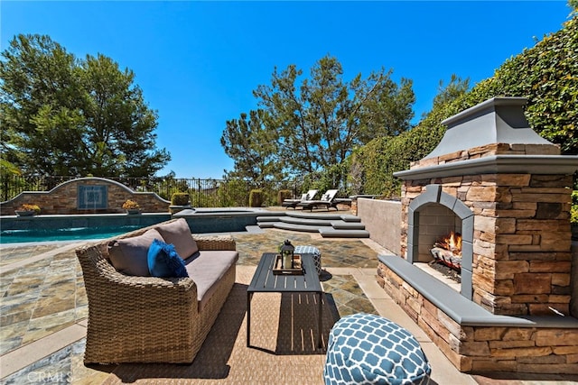 view of patio featuring an outdoor living space with a fireplace