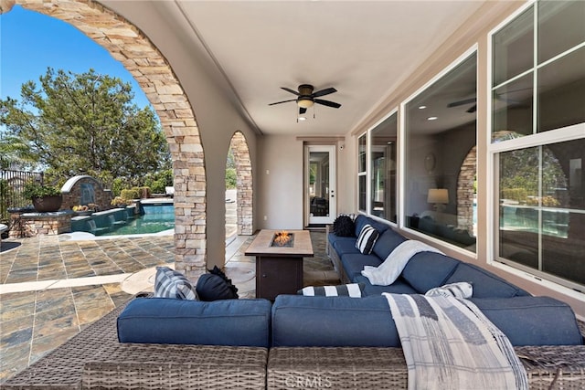 view of patio with ceiling fan and a fire pit