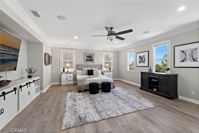 bedroom featuring ceiling fan, crown molding, and light hardwood / wood-style floors