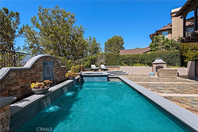 view of pool featuring pool water feature and a patio