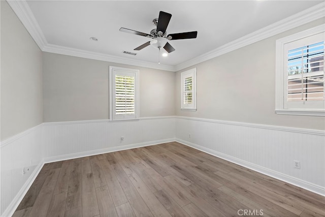 spare room with ceiling fan, light hardwood / wood-style floors, and crown molding