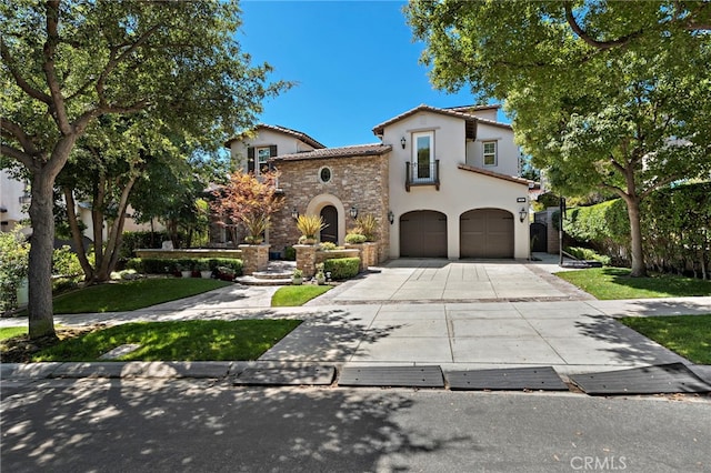 mediterranean / spanish house with a garage