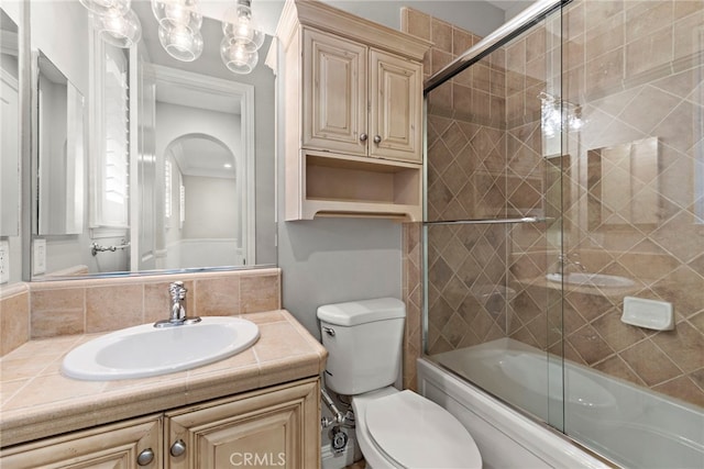 full bathroom with vanity, shower / bath combination with glass door, and toilet