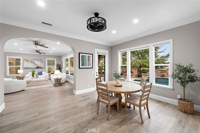 dining space featuring crown molding, ceiling fan, and light hardwood / wood-style flooring