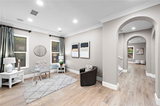 living area with light hardwood / wood-style flooring and ornamental molding