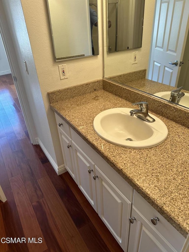 bathroom featuring wood-type flooring and vanity