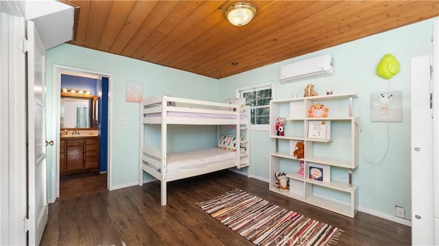 bedroom featuring a wall mounted AC, dark hardwood / wood-style flooring, ensuite bath, and wood ceiling