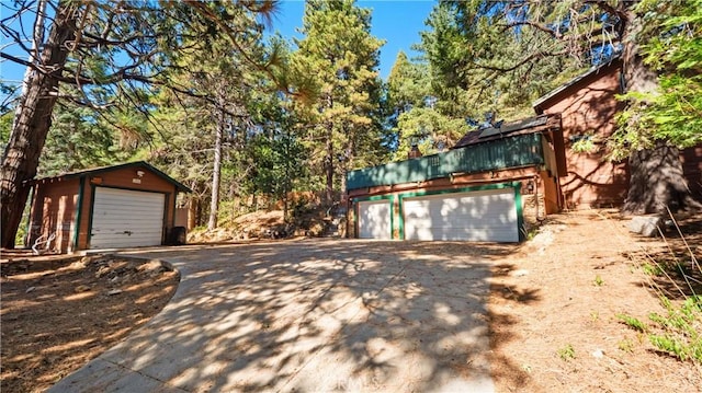 exterior space with a garage and an outdoor structure