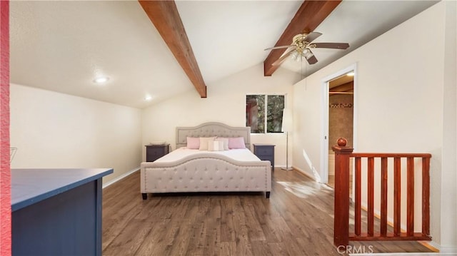 bedroom with lofted ceiling with beams, ceiling fan, and dark wood-type flooring