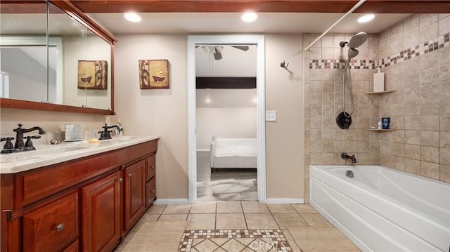 bathroom with vanity and tiled shower / bath