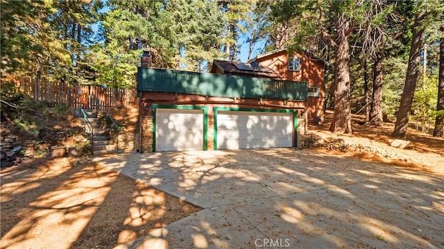 exterior space with solar panels and a garage