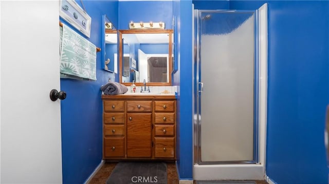 bathroom featuring vanity and a shower with shower door