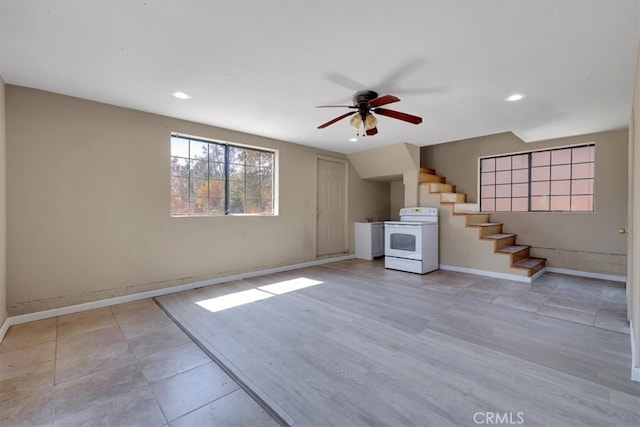 unfurnished living room with light hardwood / wood-style floors and ceiling fan