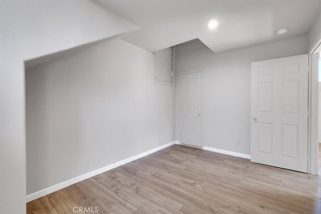 additional living space featuring light hardwood / wood-style flooring