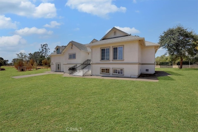 back of house featuring a lawn