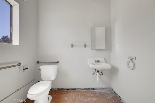 bathroom featuring tile patterned flooring, sink, and toilet