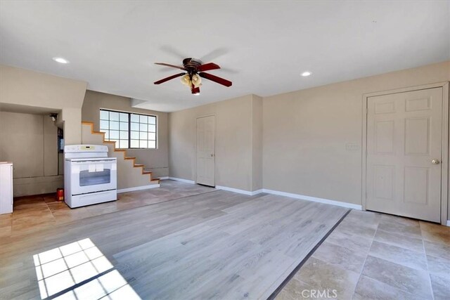 unfurnished living room featuring light hardwood / wood-style flooring and ceiling fan