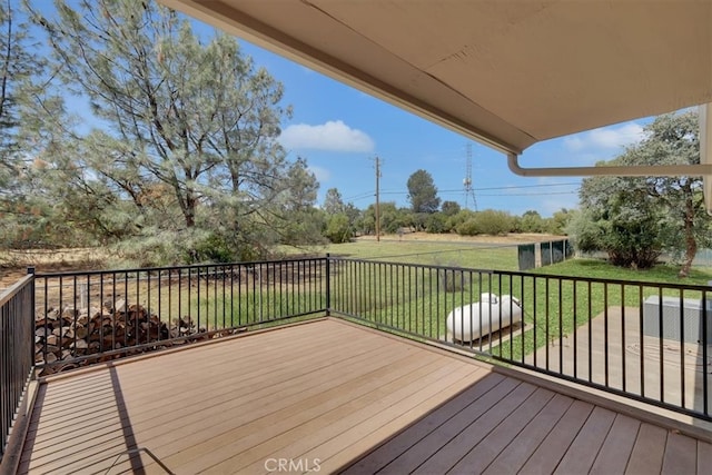 wooden terrace featuring a yard