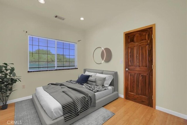 bedroom with light hardwood / wood-style flooring