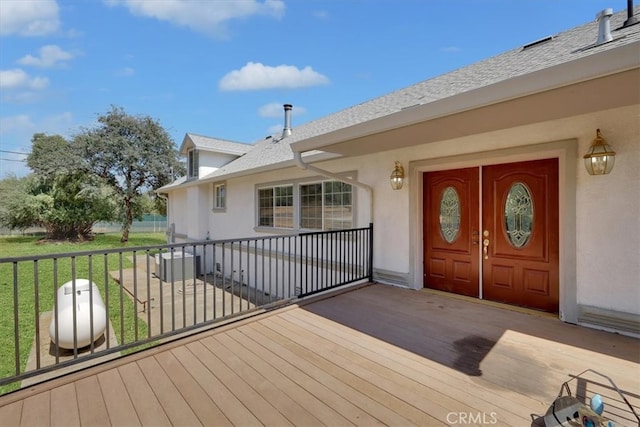 view of exterior entry with a yard