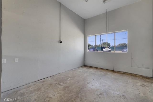 unfurnished room featuring concrete floors