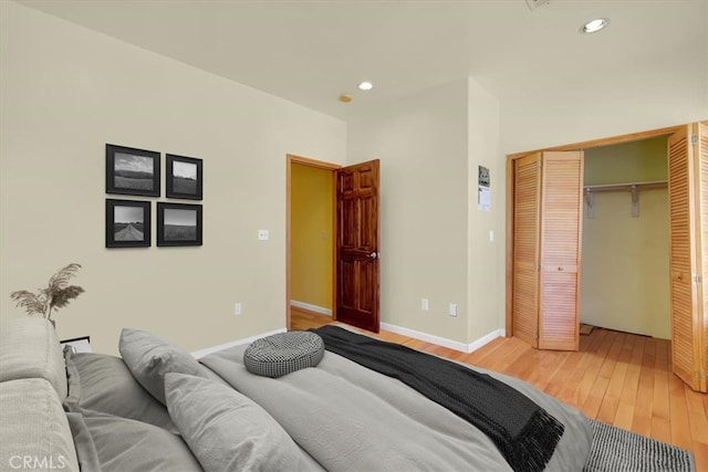 bedroom with a closet and hardwood / wood-style floors