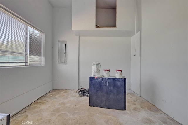 interior space featuring electric panel and concrete floors