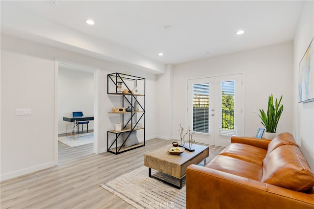 living room with light hardwood / wood-style flooring and french doors