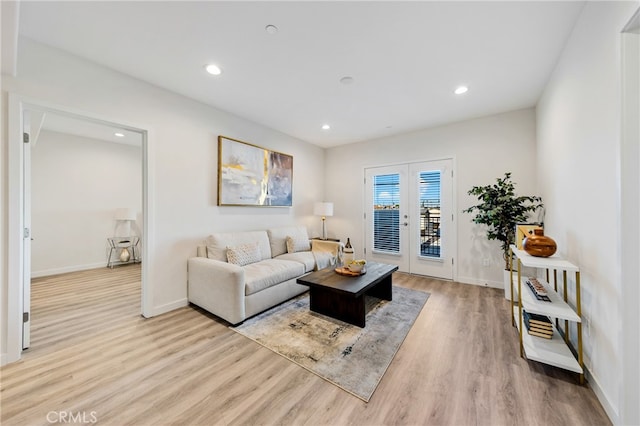 living room with light hardwood / wood-style flooring and french doors