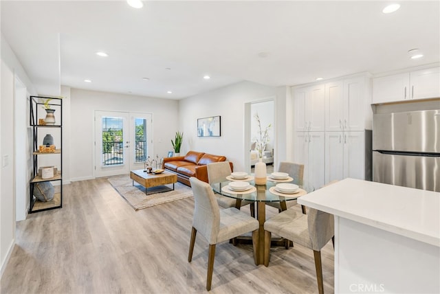 dining area featuring french doors and light hardwood / wood-style floors