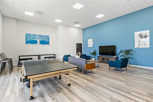 recreation room featuring light wood-type flooring and a paneled ceiling