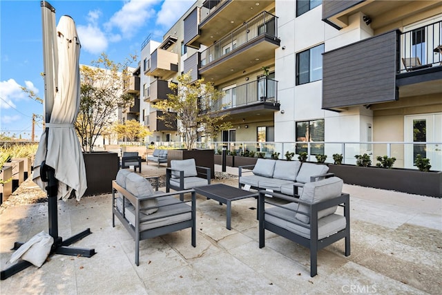 view of patio featuring a balcony and outdoor lounge area