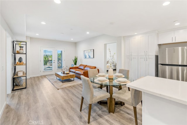 dining room with french doors and light wood-type flooring