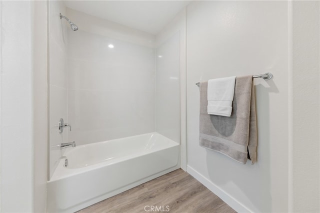 bathroom featuring shower / bathing tub combination and hardwood / wood-style flooring