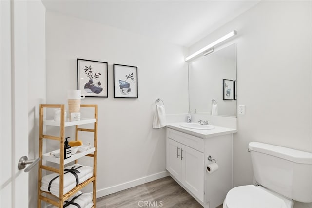 bathroom featuring hardwood / wood-style floors, vanity, and toilet