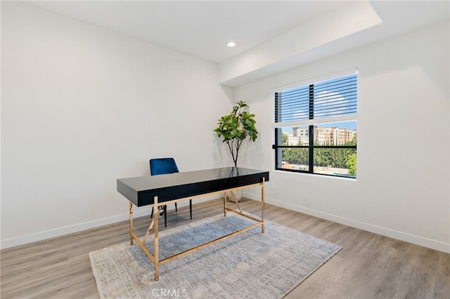 office with light wood-type flooring