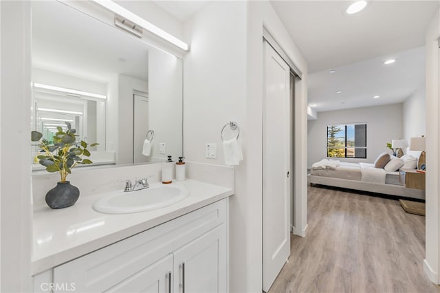 bathroom with hardwood / wood-style floors and vanity