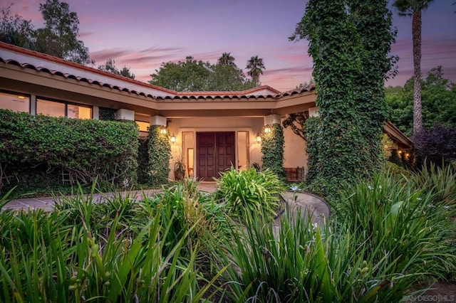 view of exterior entry at dusk