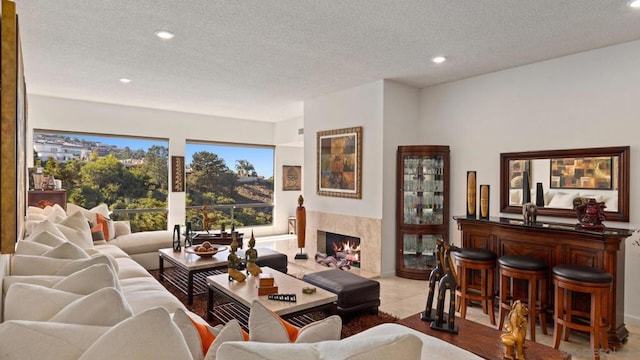 carpeted living room with a textured ceiling and a fireplace