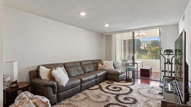 living room with a textured ceiling and hardwood / wood-style flooring