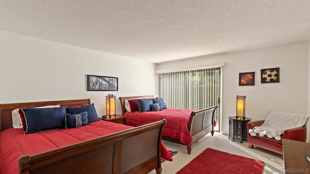 bedroom featuring a textured ceiling and light carpet