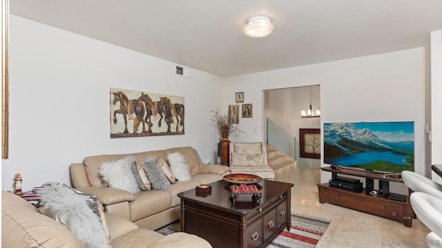 living room with a notable chandelier and light tile patterned floors