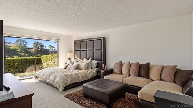 bedroom featuring a textured ceiling and carpet flooring