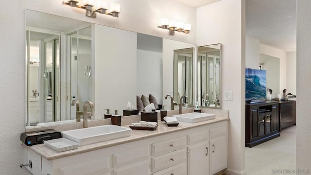 bathroom with a textured ceiling and vanity