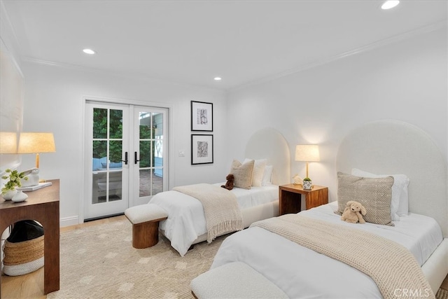 bedroom featuring light hardwood / wood-style floors, french doors, ornamental molding, and access to exterior