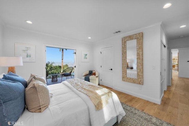 bedroom with light hardwood / wood-style flooring, access to outside, and crown molding